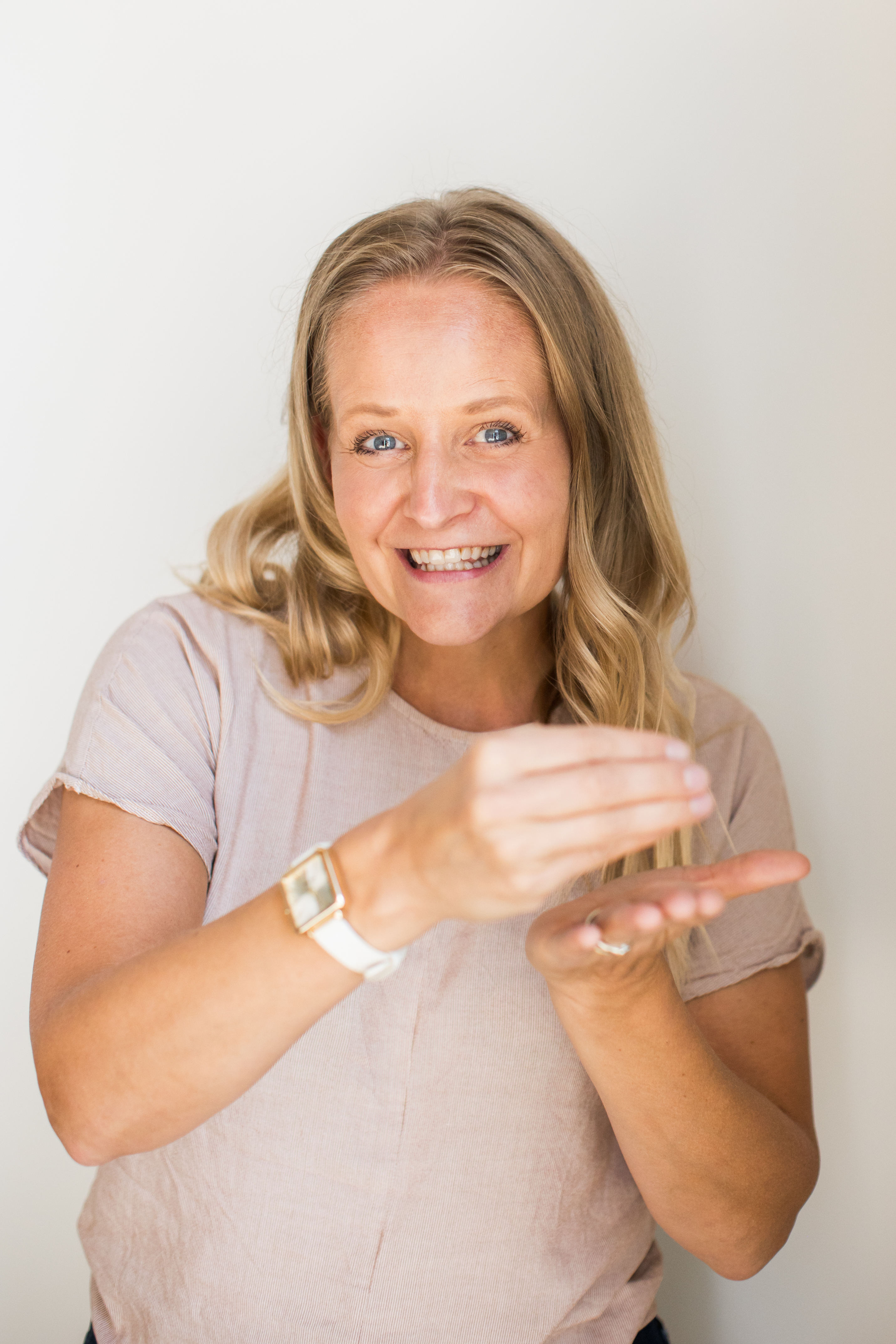 Toni Schafer demonstrating the American Sign Language sign for the word Buy, showing the direct connection between ASL and real estate transactions